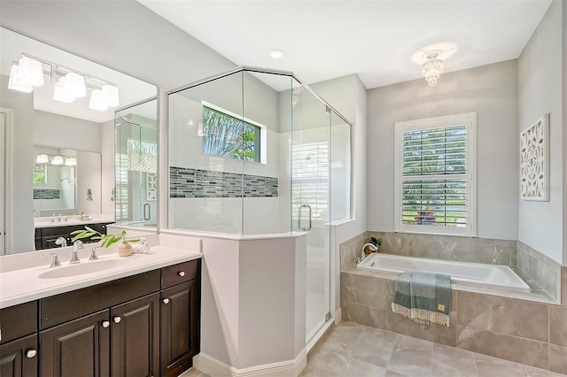 bathroom with tile patterned floors, vanity, and independent shower and bath