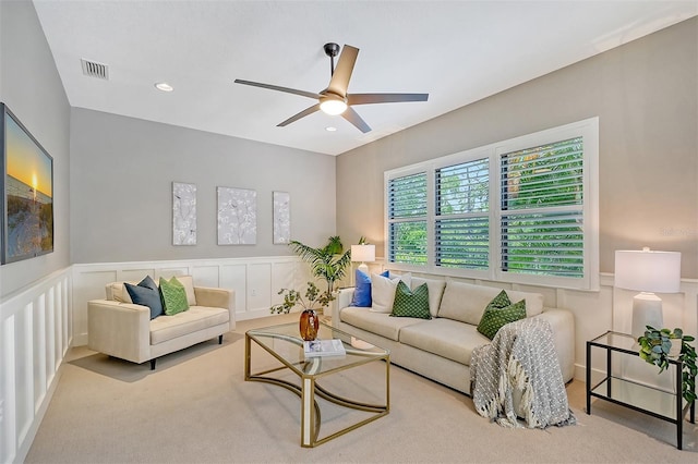 carpeted living room with ceiling fan