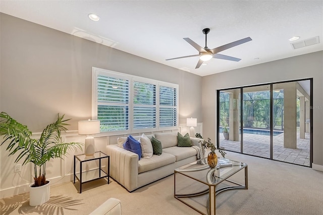 living room featuring light carpet and ceiling fan