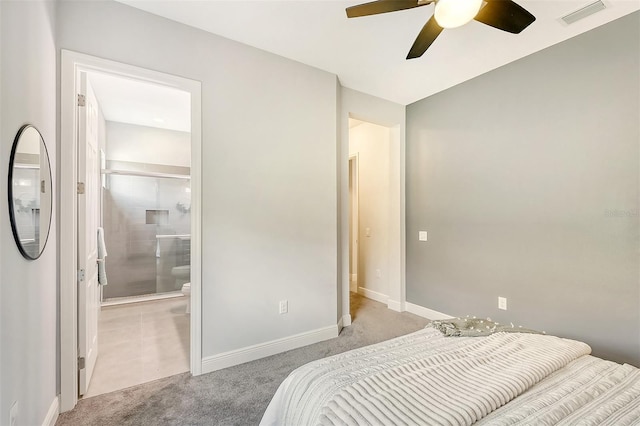 bedroom with ensuite bath, ceiling fan, and light colored carpet