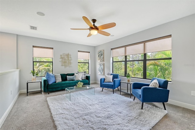 living area with ceiling fan and carpet floors