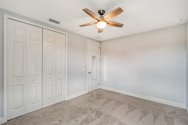 unfurnished bedroom with ceiling fan, a closet, and light colored carpet