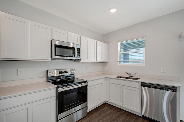 kitchen featuring sink, white cabinets, stainless steel appliances, and dark hardwood / wood-style floors