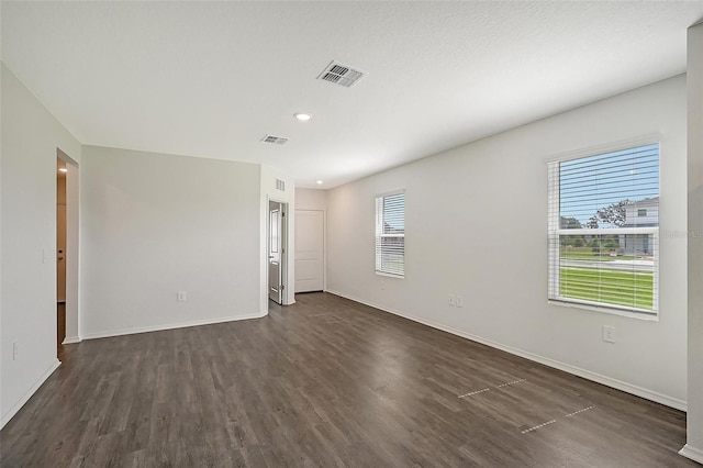 unfurnished room featuring dark hardwood / wood-style flooring