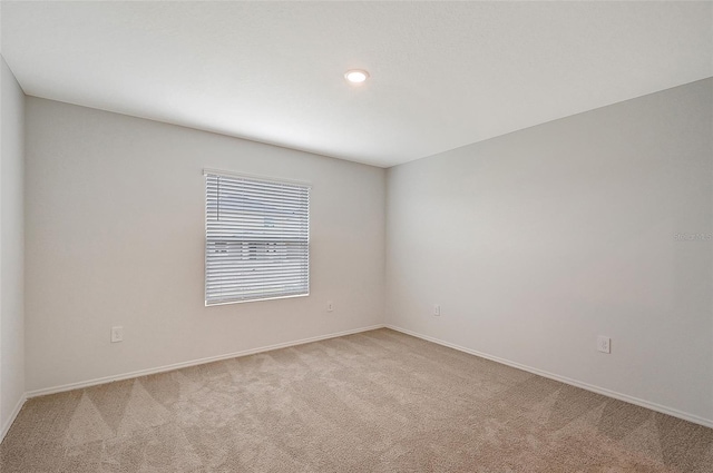 empty room featuring light carpet