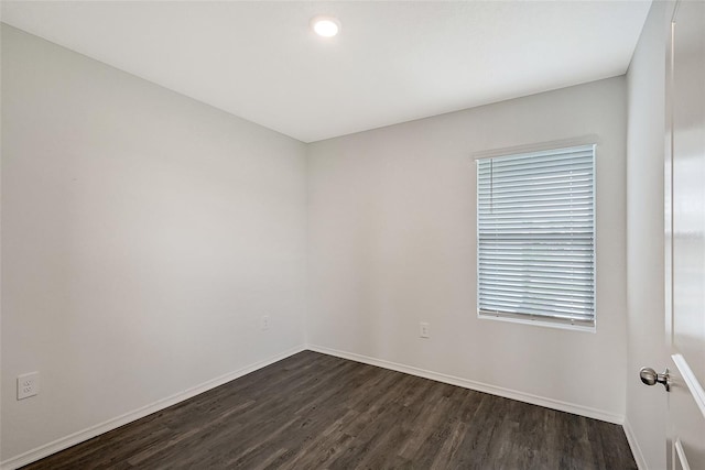 unfurnished room with dark hardwood / wood-style floors