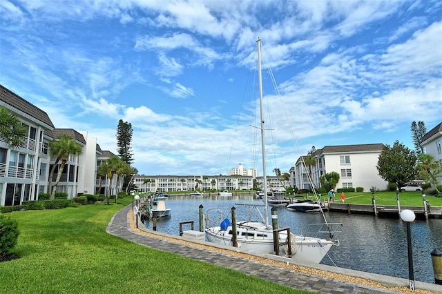 dock area featuring a lawn and a water view