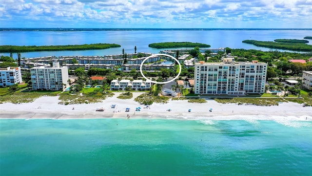 birds eye view of property with a water view and a view of the beach