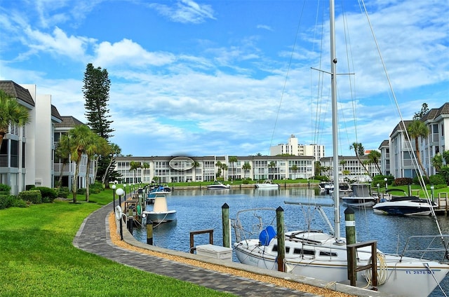 view of dock featuring a water view and a lawn