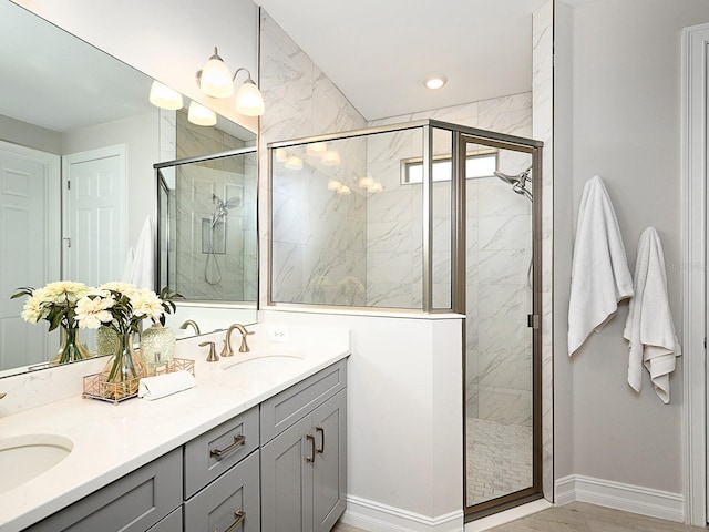 bathroom featuring vanity and an enclosed shower