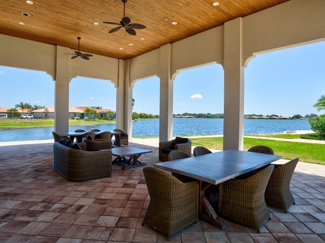 view of patio / terrace with ceiling fan and a water view