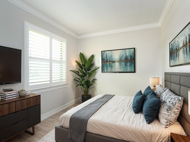 bedroom featuring ornamental molding and light wood-type flooring