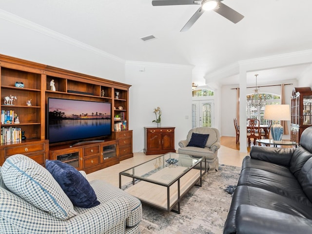 tiled living room with ceiling fan with notable chandelier and ornamental molding