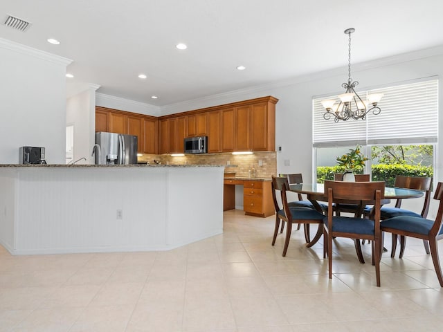 kitchen with light stone counters, kitchen peninsula, crown molding, pendant lighting, and appliances with stainless steel finishes