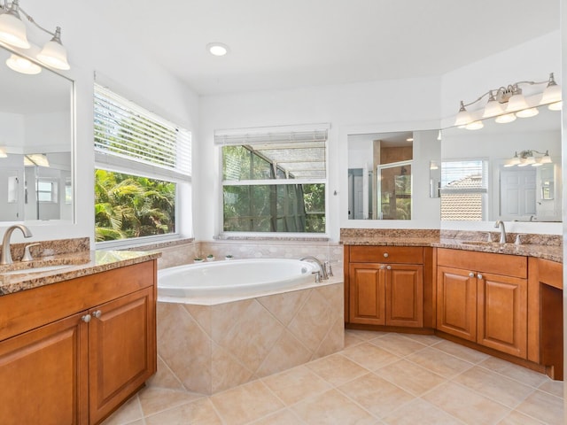 bathroom with shower with separate bathtub, vanity, and tile patterned floors