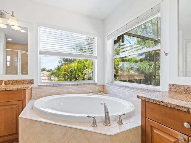 bathroom with vanity and shower with separate bathtub