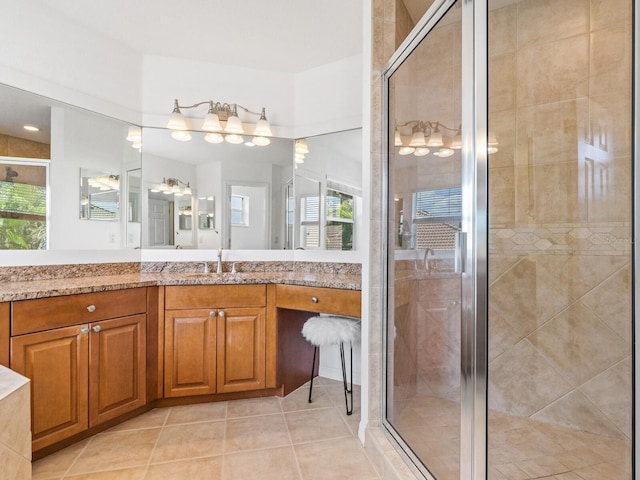 bathroom featuring tile patterned floors, vanity, and a shower with door