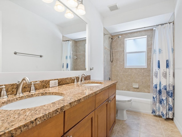 full bathroom featuring tile patterned flooring, shower / bath combo, toilet, and vanity