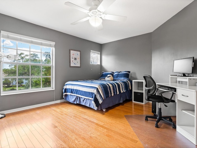 bedroom with ceiling fan and light hardwood / wood-style flooring