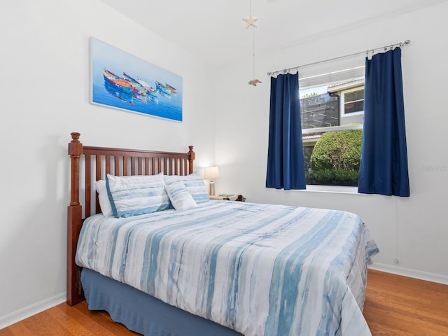 bedroom with hardwood / wood-style floors