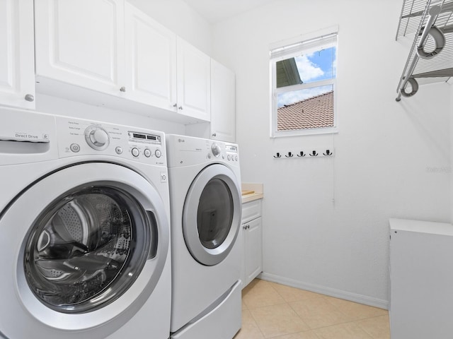 laundry room with cabinets and washing machine and dryer