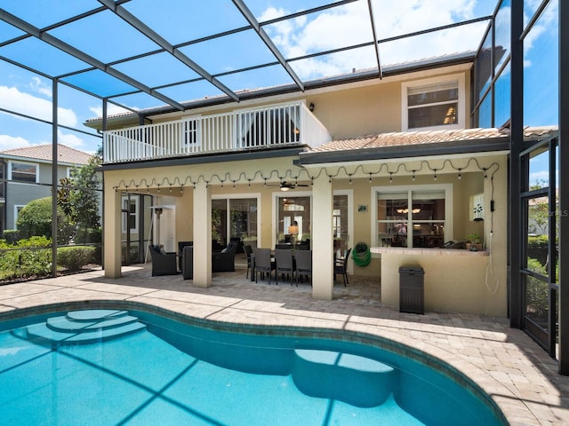 back of house featuring outdoor lounge area, ceiling fan, a lanai, a balcony, and a patio