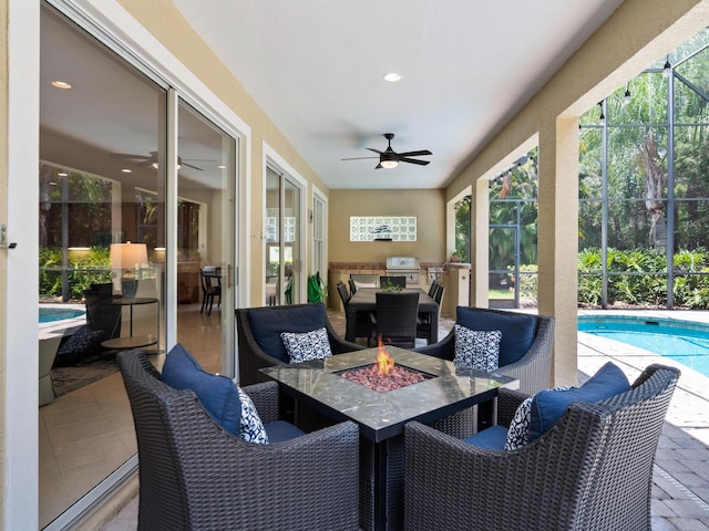 sunroom / solarium with ceiling fan, a pool, and plenty of natural light