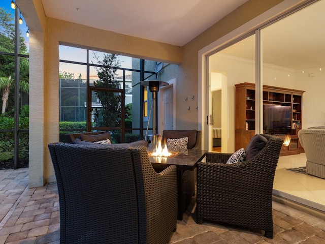 patio terrace at dusk featuring glass enclosure