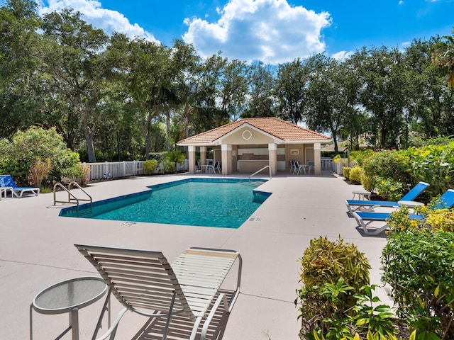 view of pool featuring a patio and an outdoor structure