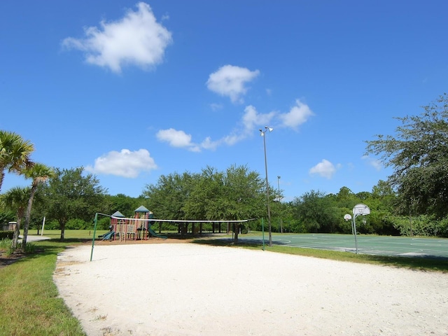 view of community featuring basketball hoop and a playground