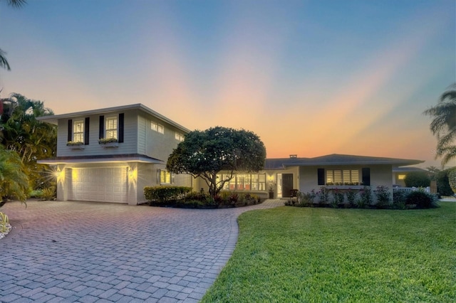 view of front of home featuring a yard and a garage