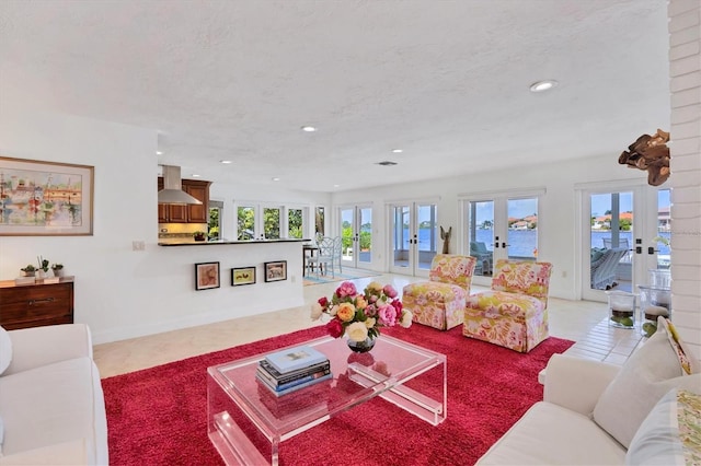 tiled living room with a textured ceiling and french doors