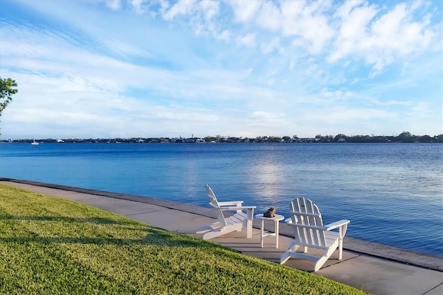 view of dock featuring a water view and a lawn