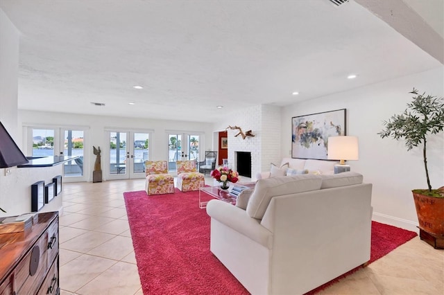 tiled living room with a fireplace, french doors, and plenty of natural light