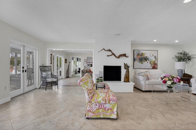 living room with a textured ceiling, french doors, and a fireplace