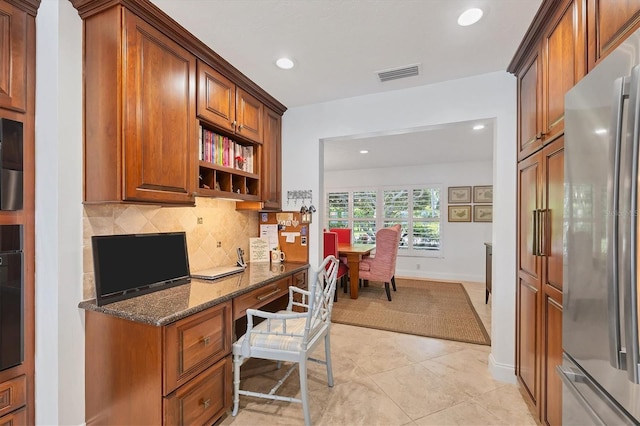 office area featuring built in desk and light tile patterned flooring