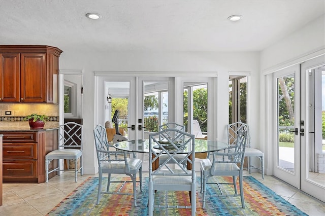 sunroom / solarium with a healthy amount of sunlight and french doors