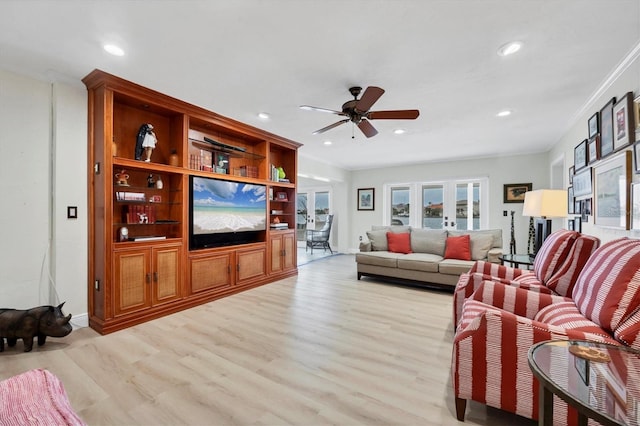 living room with ceiling fan, light hardwood / wood-style flooring, ornamental molding, and french doors