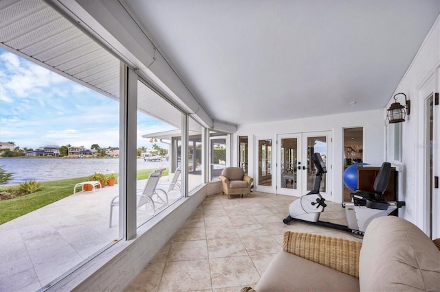 sunroom with a water view and french doors