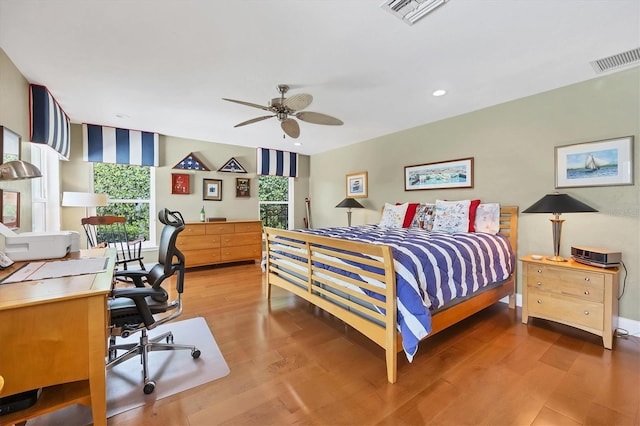 bedroom with ceiling fan and wood-type flooring