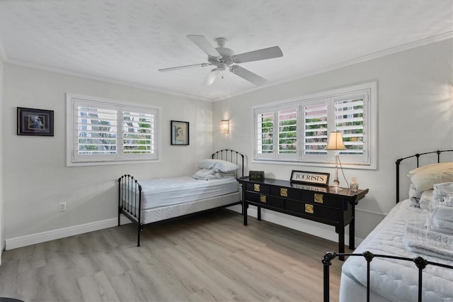 bedroom with ceiling fan, ornamental molding, and light hardwood / wood-style floors