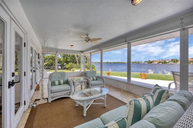 sunroom / solarium with a water view and ceiling fan