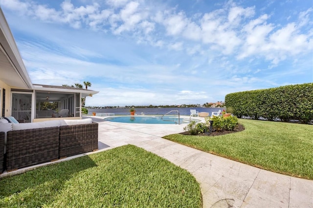 view of swimming pool featuring a patio area, a sunroom, and a yard