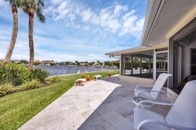 view of patio / terrace featuring a sunroom and a water view