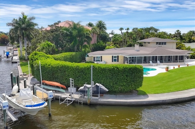 view of dock with a yard and a water view