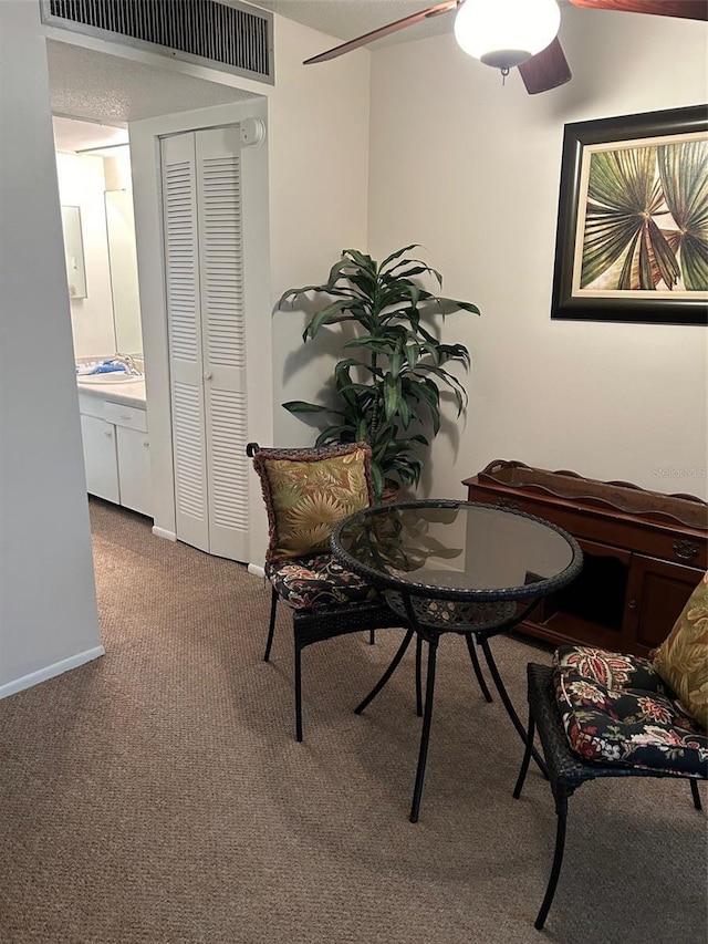 carpeted dining space with visible vents and baseboards