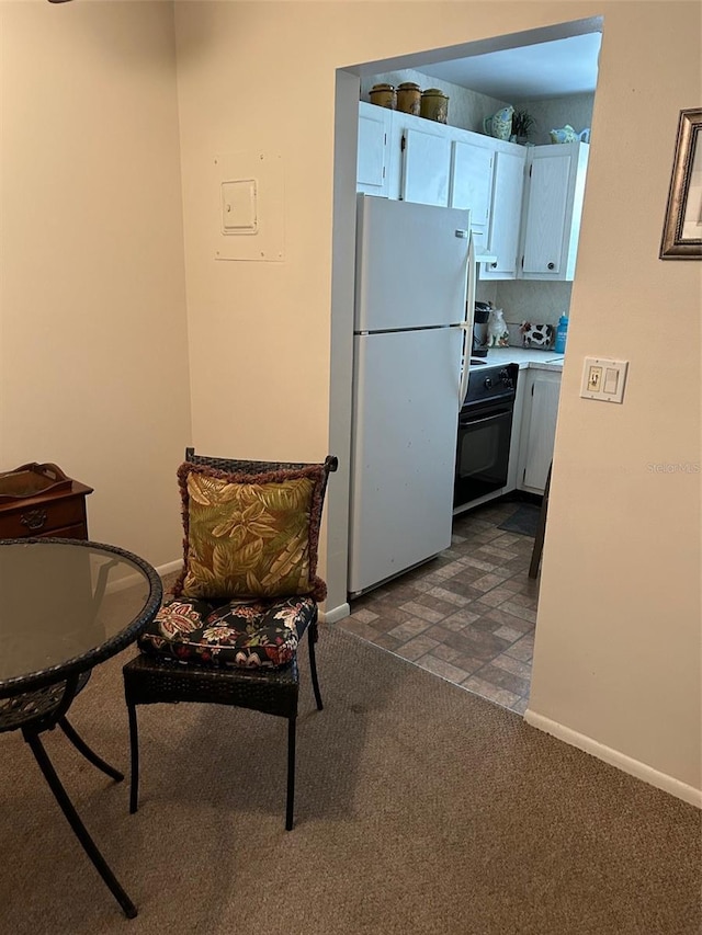 interior space with dark colored carpet and baseboards