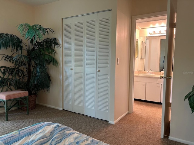 bedroom featuring light carpet, a closet, and baseboards