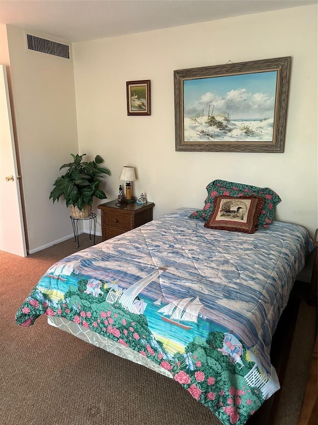 bedroom featuring carpet floors, visible vents, and baseboards