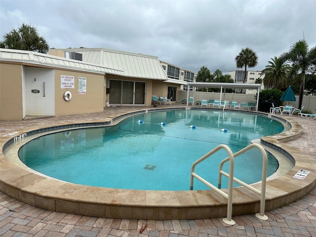 community pool with a patio area